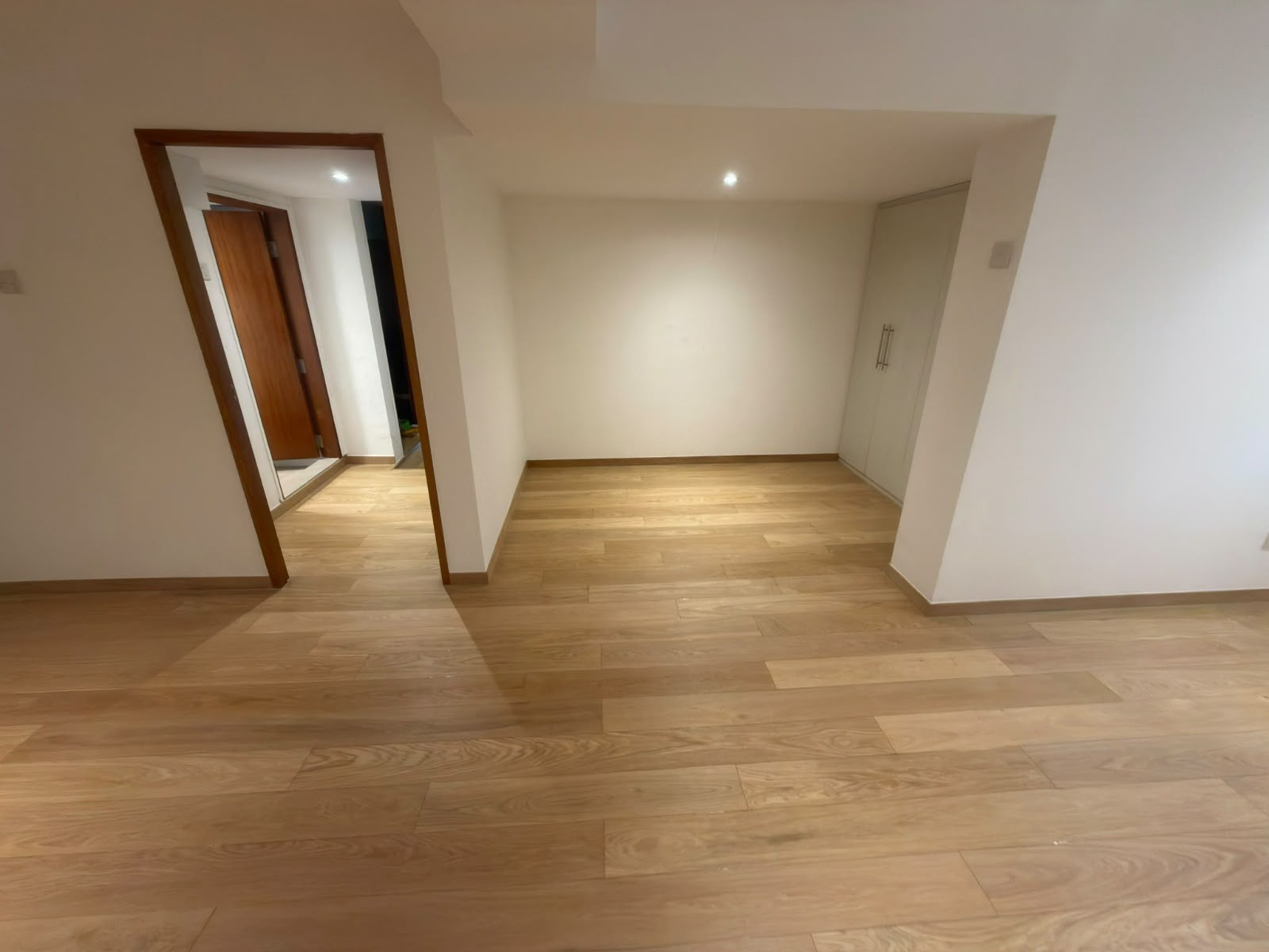 Oak floor extending through the room entrance at Seraya Lane